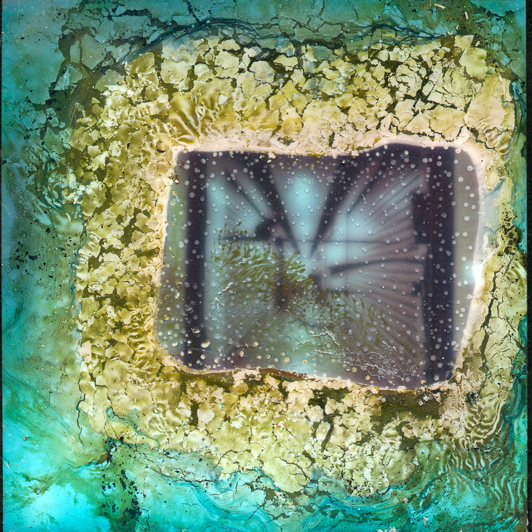 A Polaroid image that has been decayed through a chemical soak.
