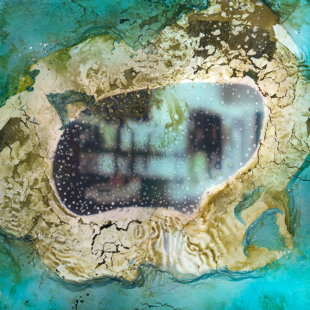 A Polaroid image that has been decayed through a chemical soak.