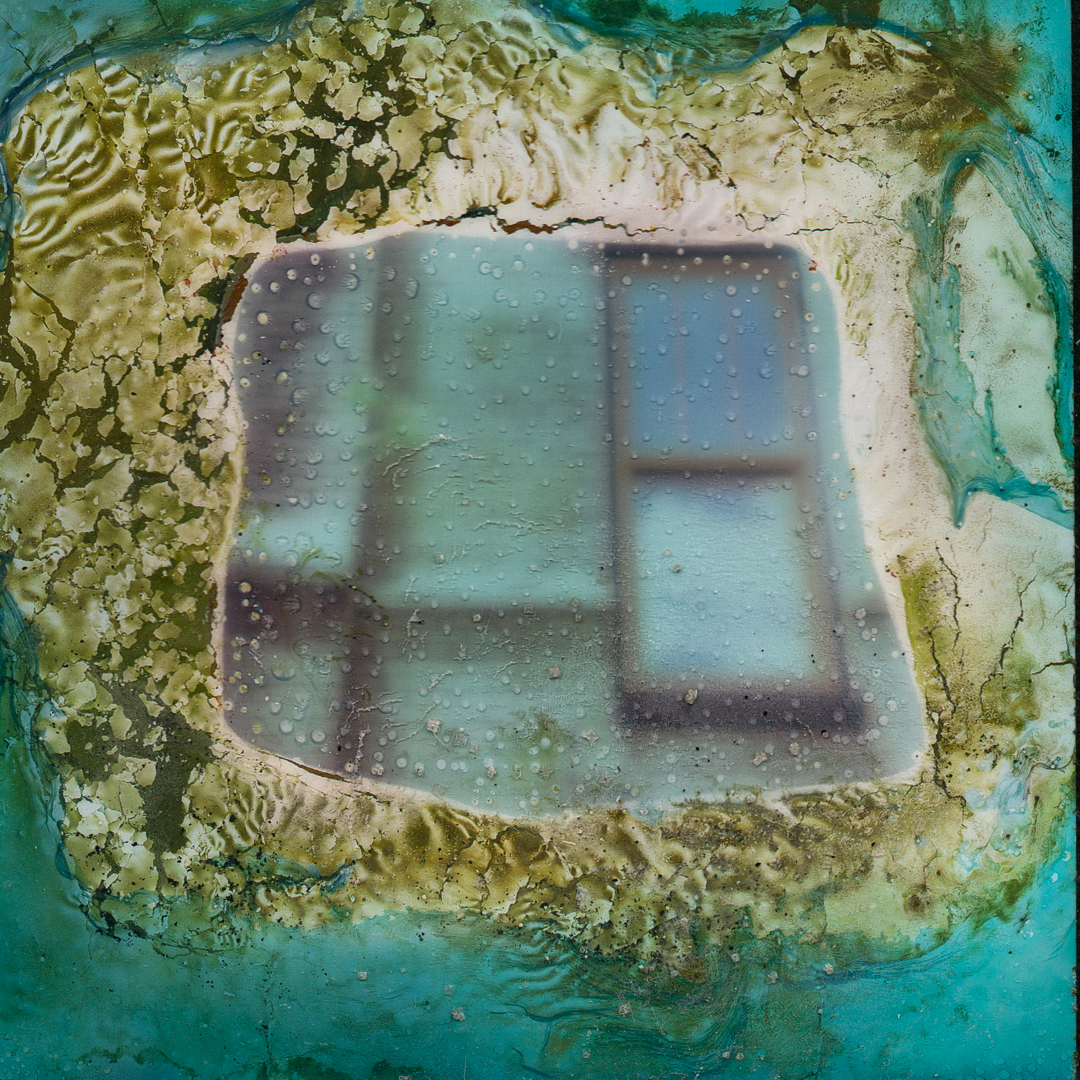 A Polaroid image that has been decayed through a chemical soak.